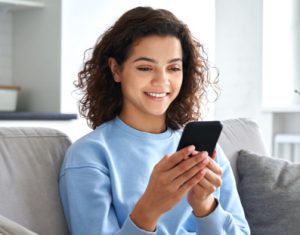 Attractive woman smiling down at phone