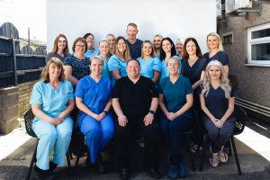 Picture of the whole Marquess dental team sat on chairs